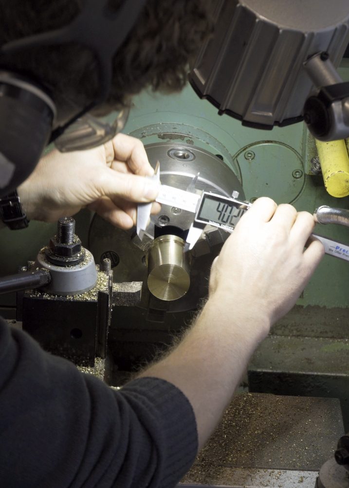 Lathework — turning and measuring a brass component in the workshop
